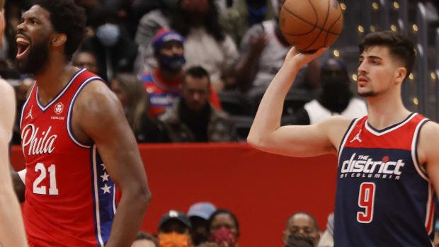 Dec 26, 2021; Washington, District of Columbia, USA; Philadelphia 76ers center Joel Embiid (21) reacts as Washington Wizards forward Deni Avdija (9) looks on. during the third quarter at Capital One Arena. Mandatory Credit: Geoff Burke-USA TODAY Sports